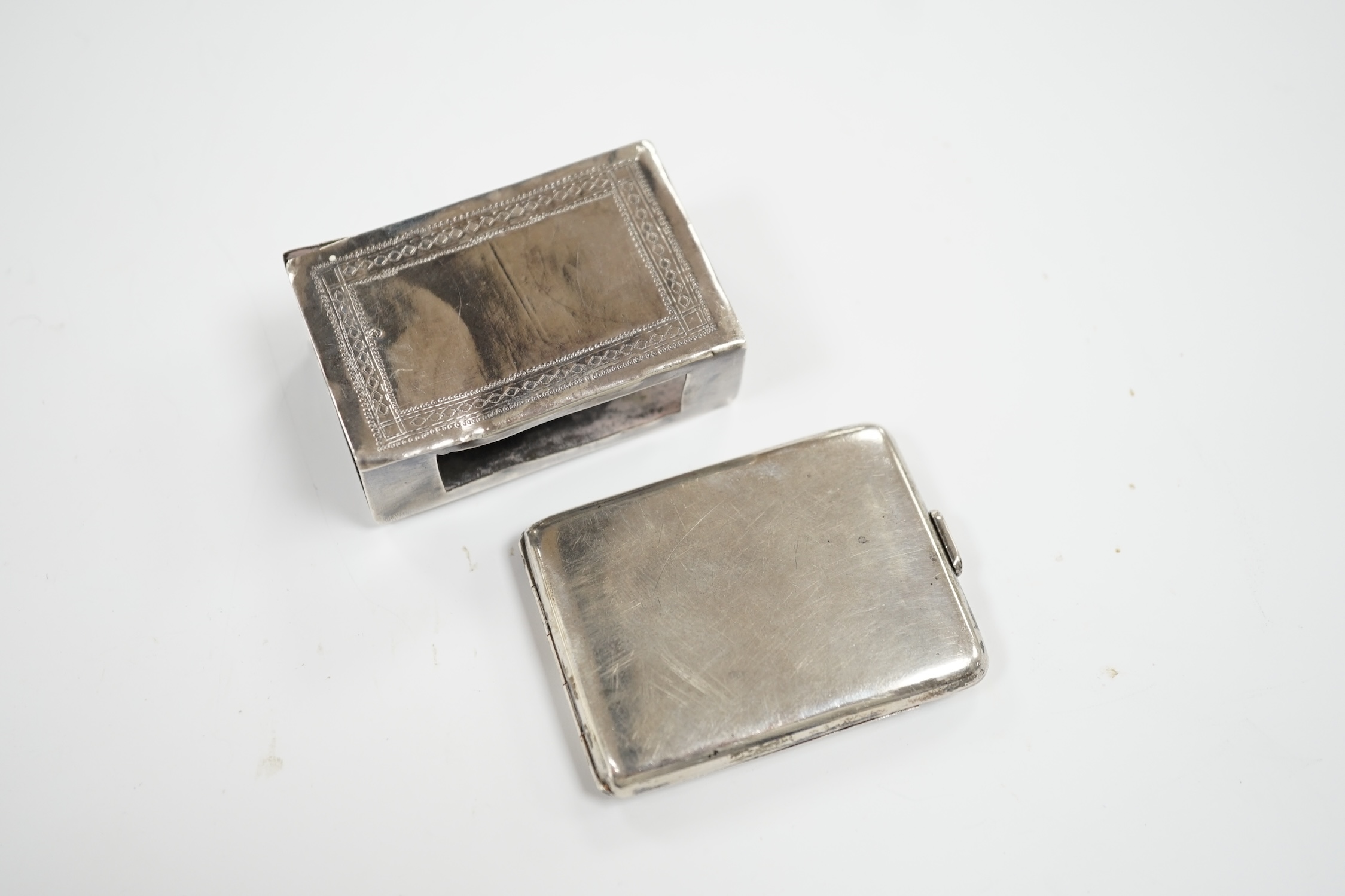 A George V engine turned silver cigarette case, Walker & Hall, London, 1935, 10.2cm and two matchbox holders, one silver.